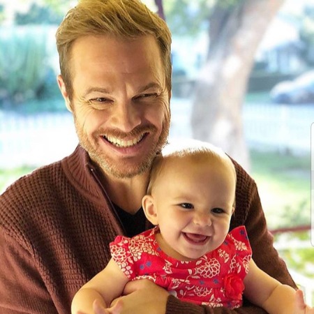George Stults with his nephew is posing for the photo.